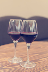 two glasses of red wine on the table, the effect of instagram