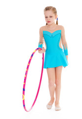 Beautiful little gymnast with the hoop
