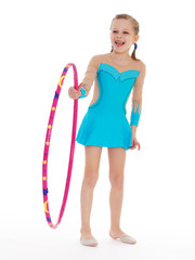 Beautiful little gymnast with the hoop