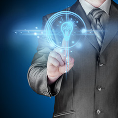 Business man touching light of idea
