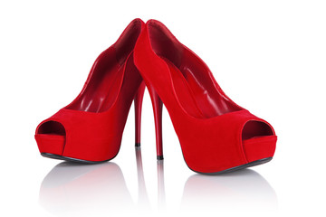 Female red high-heeled shoes over white background.