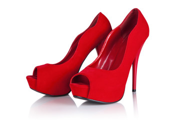 Female red high-heeled shoes over white background.