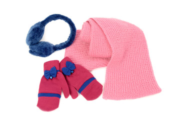 Pink wool scarf, a pair of gloves and earmuffs nicely arranged.