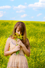 Young woman at canola field