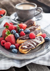 Chocolate eclairs with fresh berries