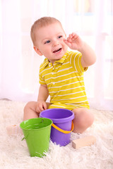 Cute little boy plating in room