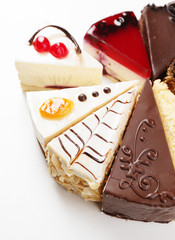 Assortment of pieces of cake, isolated on white © Africa Studio
