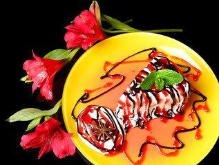 Tasty cake with cream, on black background © Africa Studio