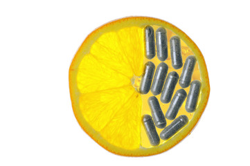 Orange slice with vitamin pills