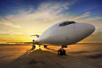 Fototapeta na wymiar Business plane at sunset - back lit