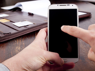 Old fashioned leather folder with a modern smartphone