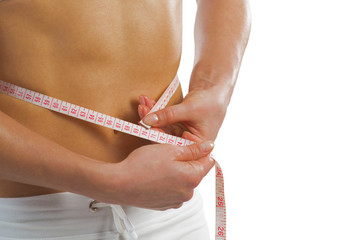 young athletic woman measuring waist