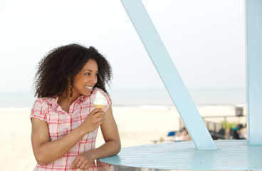 Beautiful young black woman enjoying ice cream