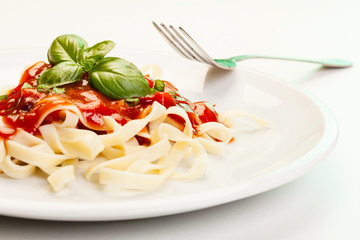 Pasta fettuccine with tomato sauce and basil