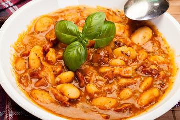 Beans with tomato sauce, bacon and sausage