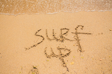 Fototapeta na wymiar Surf's up - written in the sand