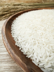 white rice on the wooden plate and rice plant