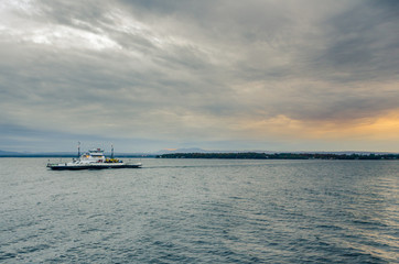 Ferry on a Lake and Cloudy Sky at Sunset
