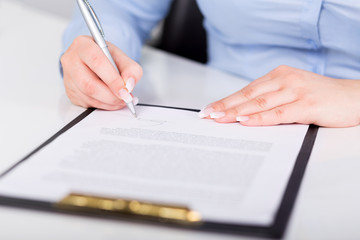 Young woman signs a contract