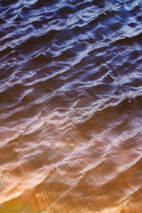 sky with clouds reflected on the water surface with waves