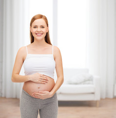 happy future mother touching her belly