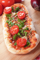 Homemade pizza with parsley and cherry tomato