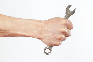 Hand of serviceman with a spanner closeup