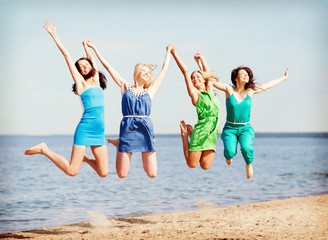 girls jumping on the beach
