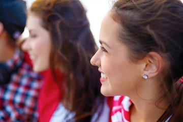 smiling teenage girl outdoors with friends