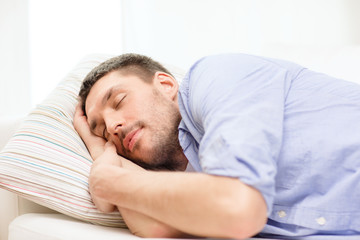 Obraz premium calm young man lying on sofa at home