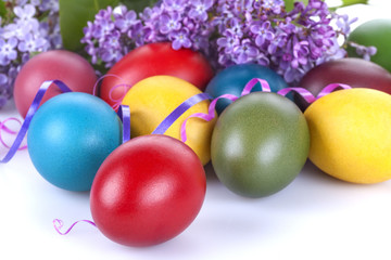 Obraz na płótnie Canvas Colorful Easter eggs with lilac flowers