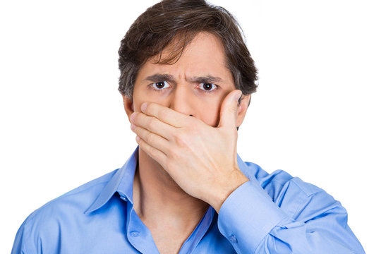 Speak no evil concept. Man covers mouth, keeps information 