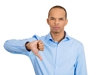 Portrait Upset, angry man giving Thumbs down gesture