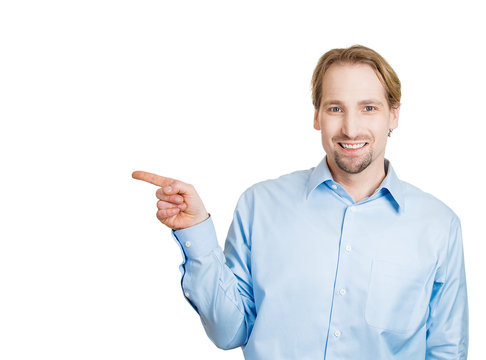 Advertising business man pointing finger at blank copy space 