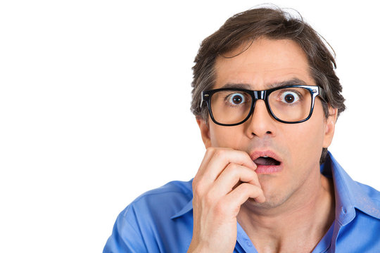 Anxious, scared, nerdy young man in glasses 