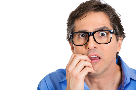 Anxious, scared, nerdy young man in glasses 