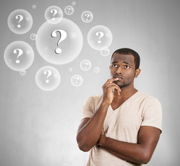 Portrait headshot Man thinking grey background question bubbles 