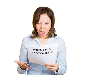Naklejka premium Expensive bill. Surprised business woman looking at statement