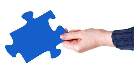 female hand with blue puzzle piece