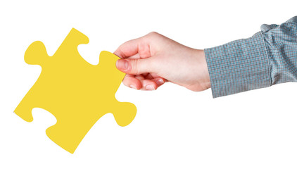 female hand with yellow puzzle piece