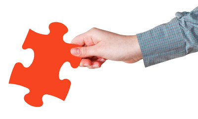 female hand with red puzzle piece