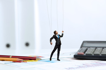 businessman puppet doll is on the desk