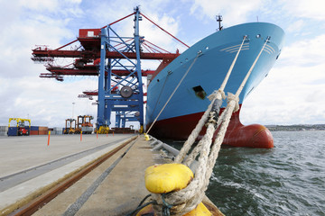container ship mored at quay-side, container cranes in port