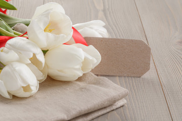 Fototapeta na wymiar white tulips on wood table