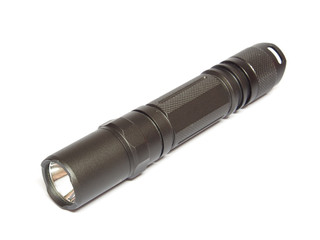 Military electric LED flashlight isolated on a white background
