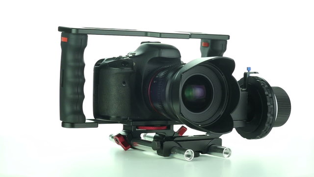 DSLR camera rotates on a white background
