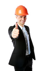 Businessman in helmet giving thumbs up over white background
