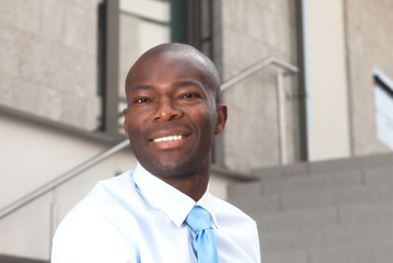 Laughing african businessman on stairs