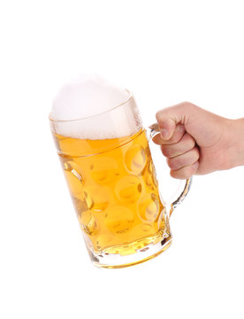 Male Hand Holding Up A Glass Of Beer.