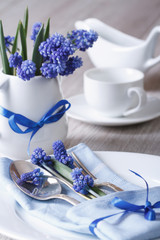 Obraz na płótnie Canvas Festive table setting with blue flowers closeup